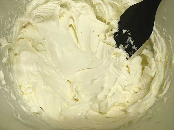 cream cheese, sugar, and cornstarch mixed together with a spatula