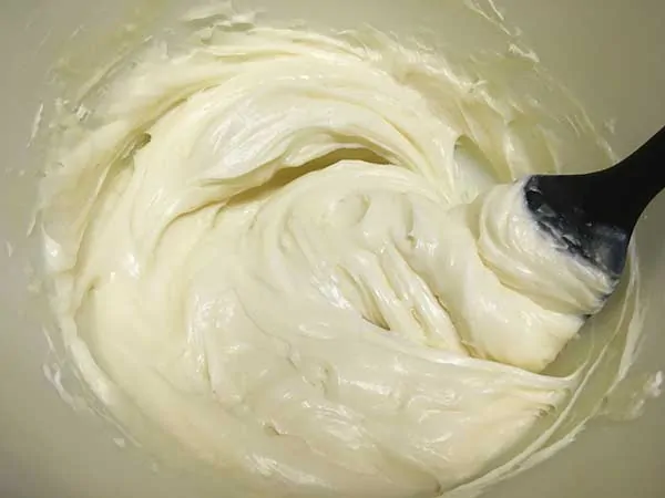 white chocolate and cream cheese mixed together with spatula