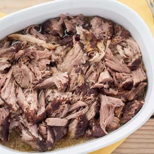 Pulled pork in white bowl.