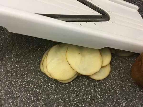 mandoline with sliced potatoes