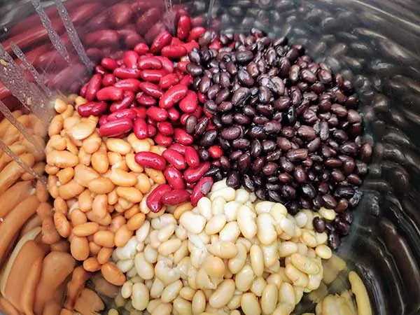 Black beans, kidney beans, pinto beans, and great northern beans in pot.