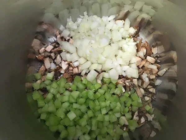 Diced onions, celery, and mushrooms in pot.