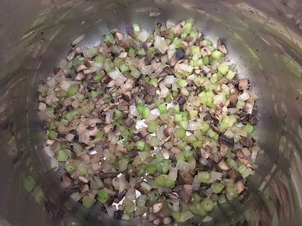 Sautéed diced onions, celery, and mushrooms in pot.