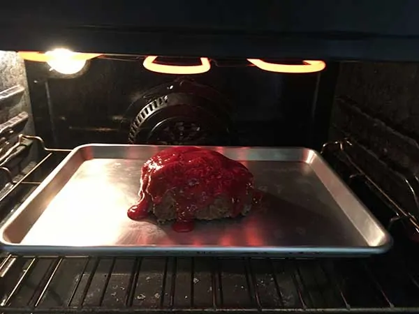 whole meatloaf under broiler on baking sheet