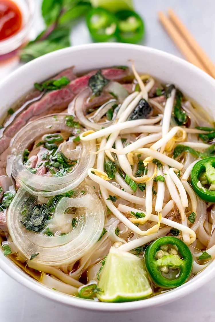 Beef pho in white bowl.