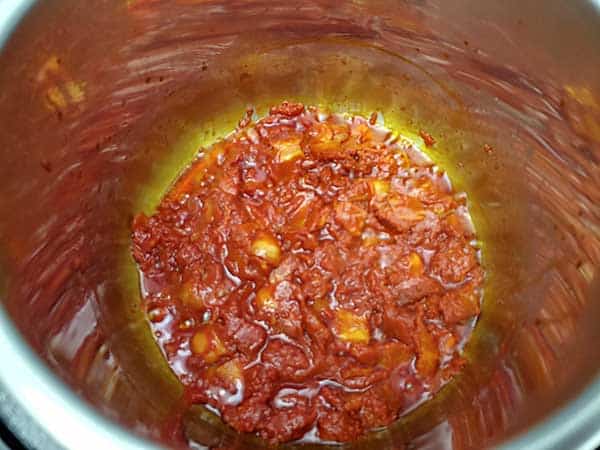 Tomato paste mixed with bacon pieces.