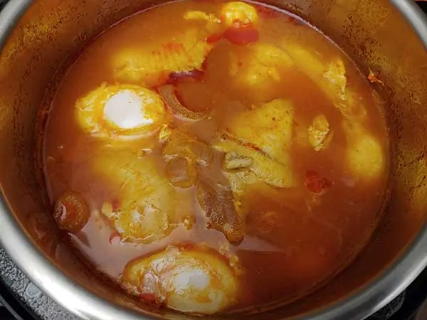 Poached eggs in top of fish stew in Instant Pot.