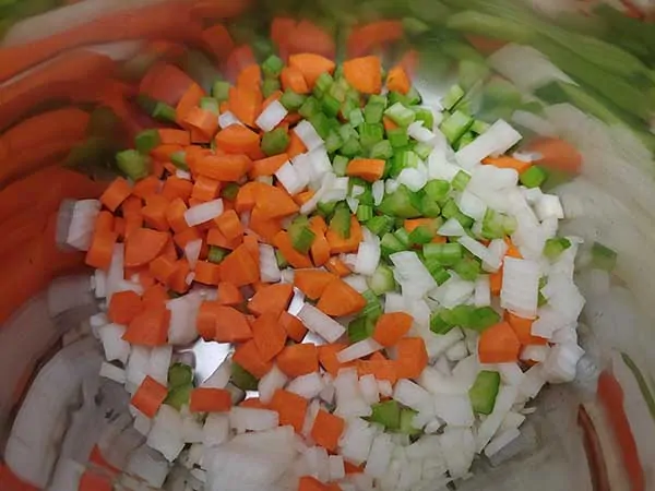 Diced onions, carrots, and celery in pot.