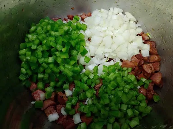 Diced onions, peppers, and celery on to of crispy sausage.