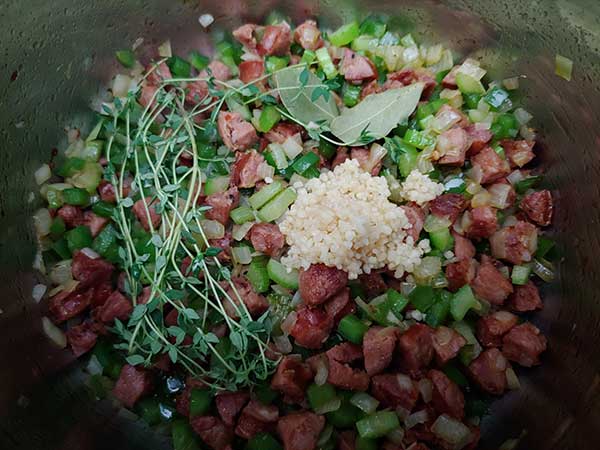 Crispy sausage, onions, peppers, and celery topped with garlic, bay leaves, and thyme.