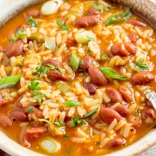 Red beans and rice in bowl with spoon.