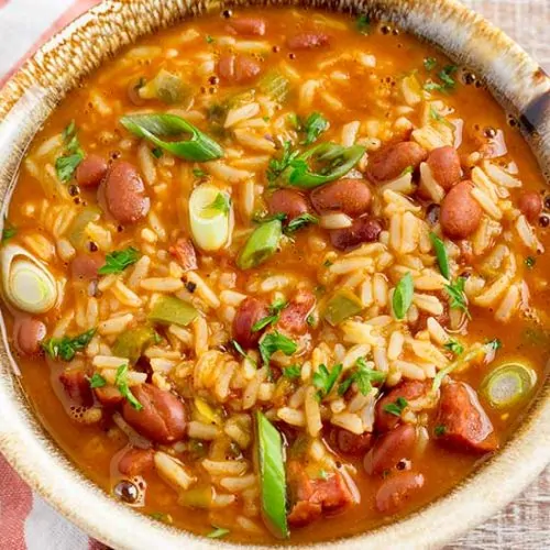 Red beans and rice in bowl with spoon.