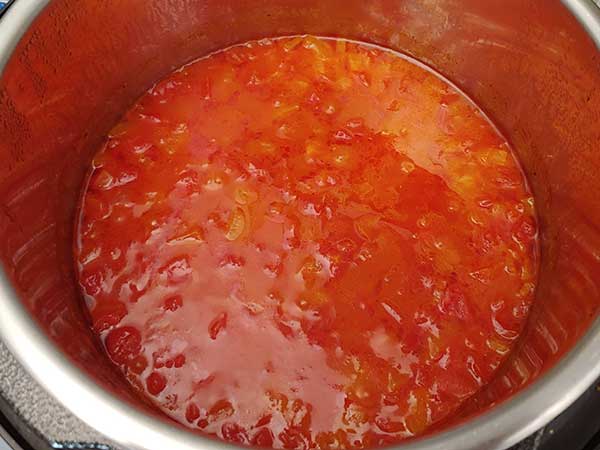 Cooked tomato basil soup in pot.
