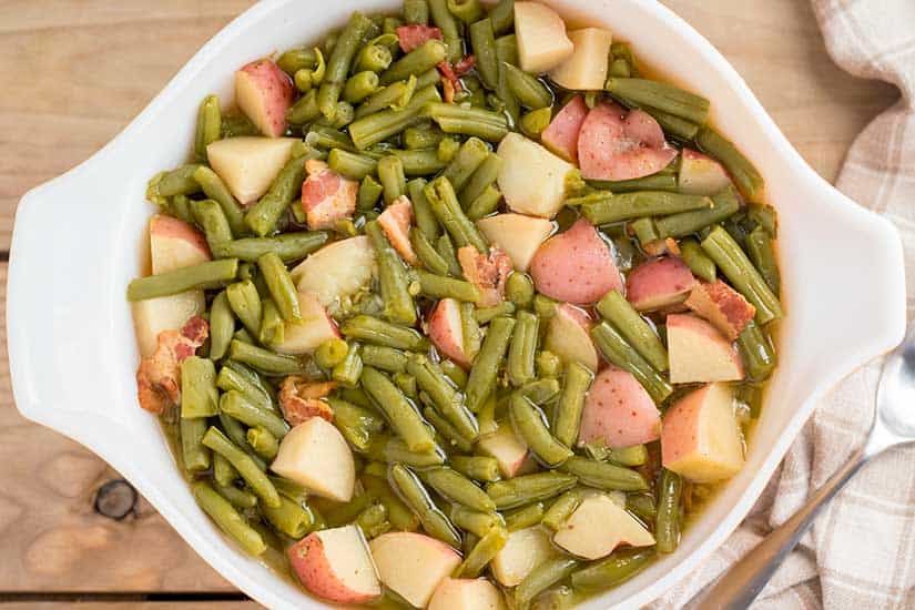Green beans with potatoes and bacon in bowl.