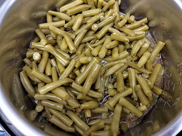 Cut green beans in Instant Pot.