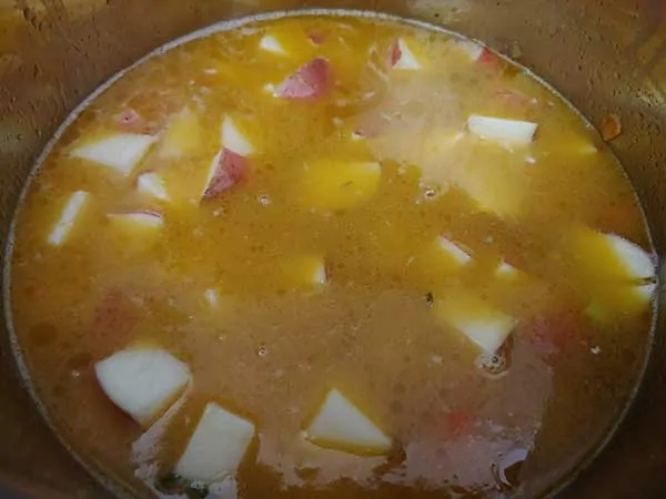 Red potatoes in chicken broth.