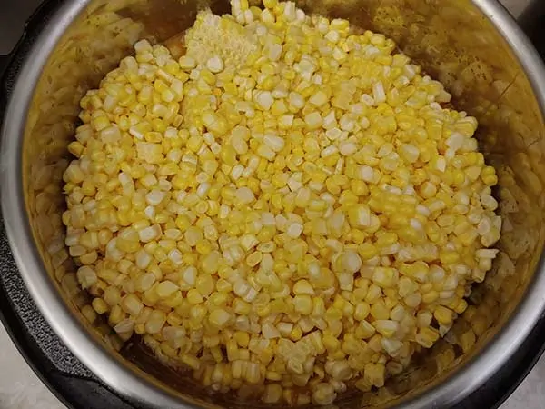 Kernels of corn on top of other chowder ingredients.
