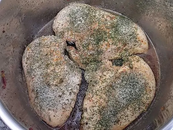 Chicken breasts seasoned with ranch spices in broth.