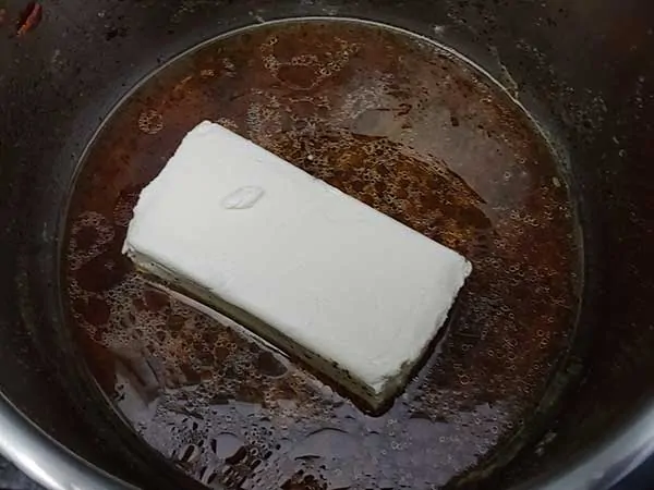 Block of cream cheese in broth.