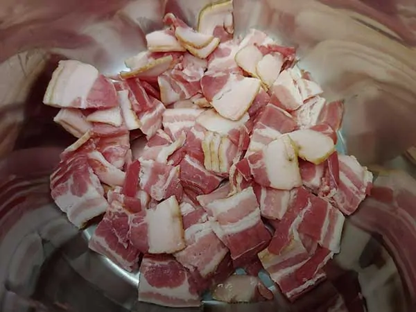 Uncooked bacon pieces in Instant Pot.