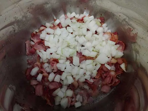 Bacon pieces topped with diced onions.