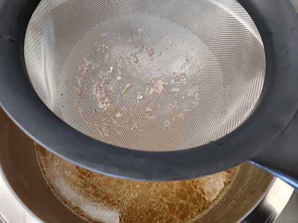 Fine mesh strainer on top of mixing bowl.