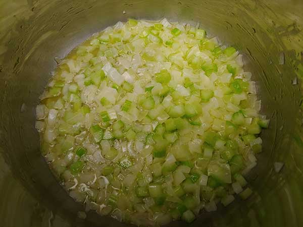 Sautéed onions and celery in pot.