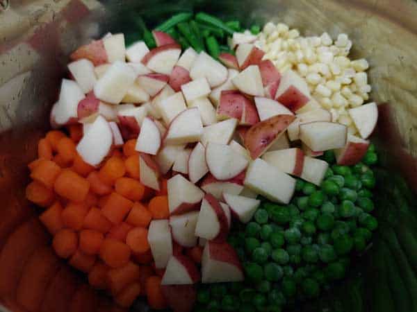 Pot pie veggies in pot - potatoes, carrots, peas, corn, and green beans.
