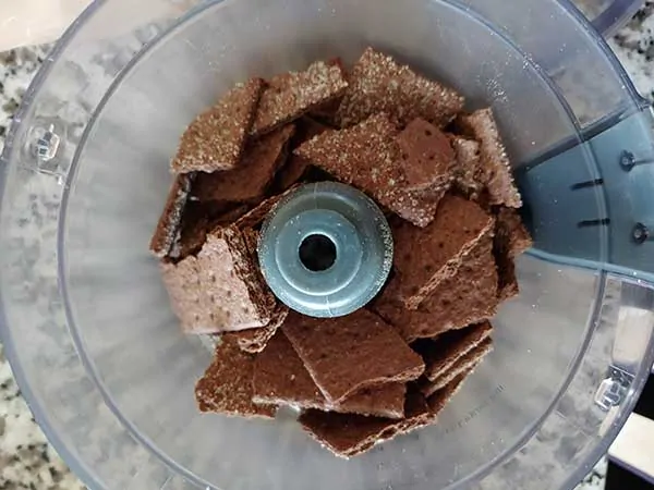 Chocolate graham crackers in food processor.