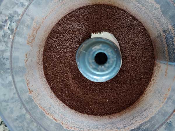 Chocolate graham cracker crumbs in food processor.