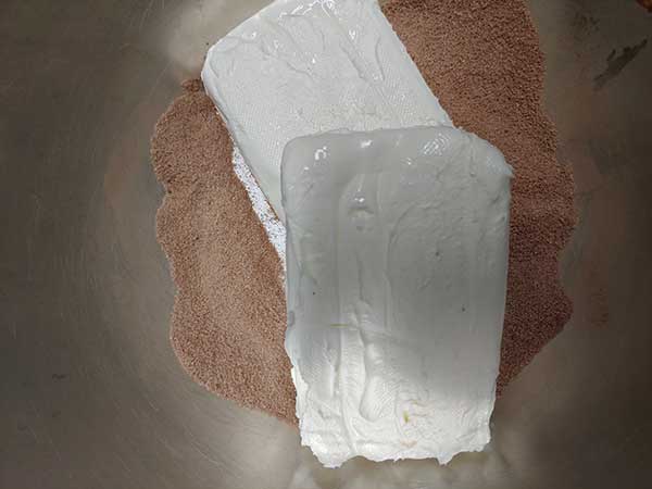 Cream cheese, sugar, and cocoa powder in mixing bowl.