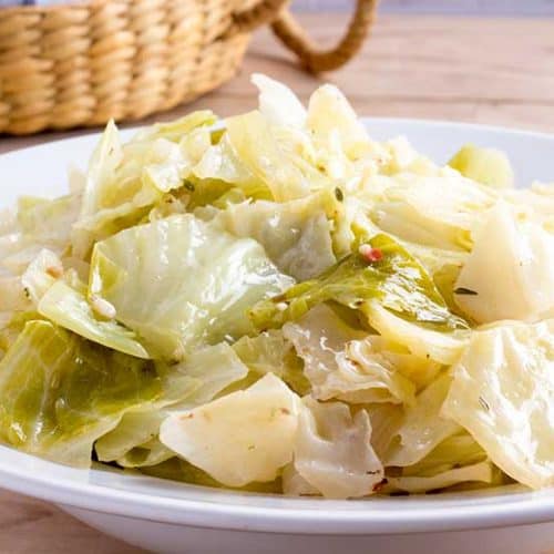 Instant Pot cabbage in white bowl with basket in background.