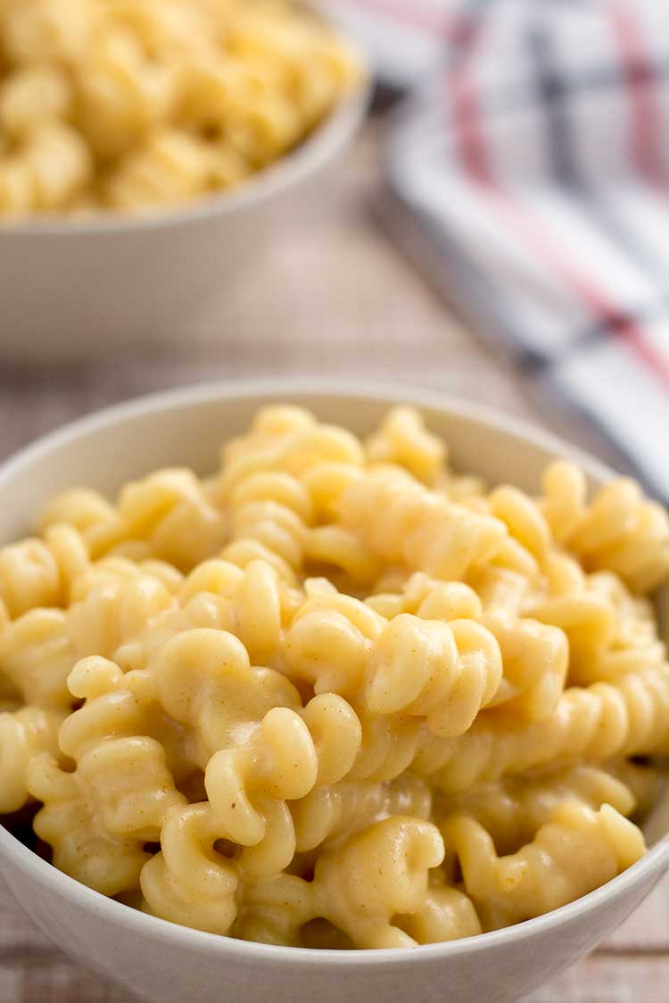 Truffled mac and cheese in white bowls.