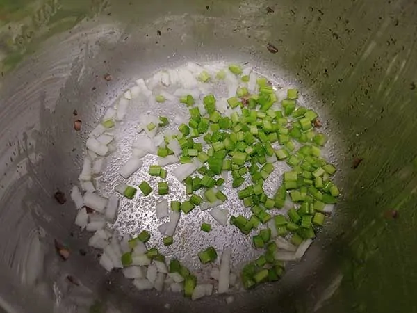 Diced onions and celery in pot.