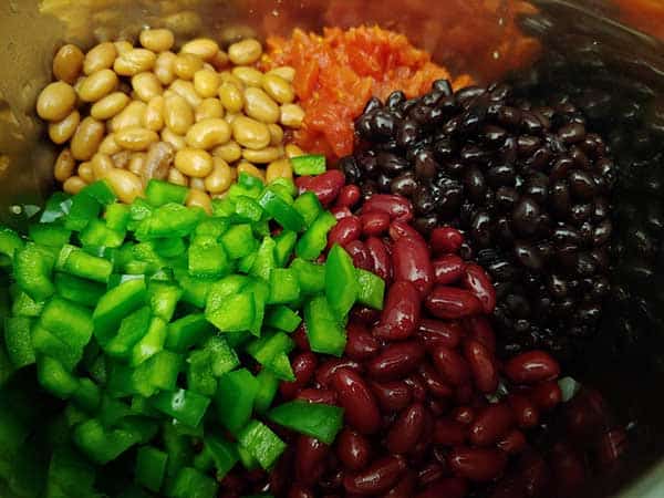 Chili vegetables in pot - beans, peppers, and tomatoes.