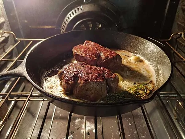 Filets in cast iron skillet in oven.