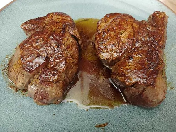 Two filets resting on plate.