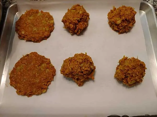 Bean burger patties on baking sheet lined with parchment paper.