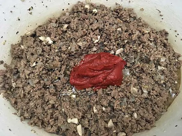 Ground beef and mushroom mixture topped with tomato paste.