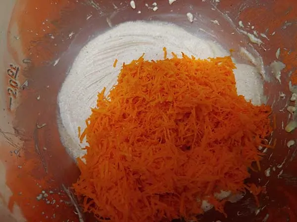 Butter, eggs, and sugar mixture topped with finely grated carrots.