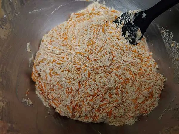 Butter, eggs, and sugar mixture combined with grated carrots.
