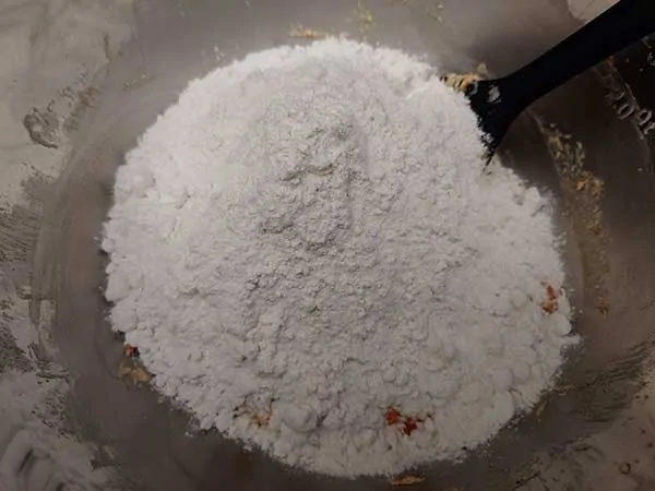 Flour and rubber spatula in mixing bowl.