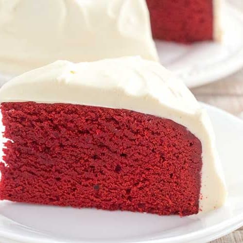 Slice of Instant Pot red velvet cake on white plate.