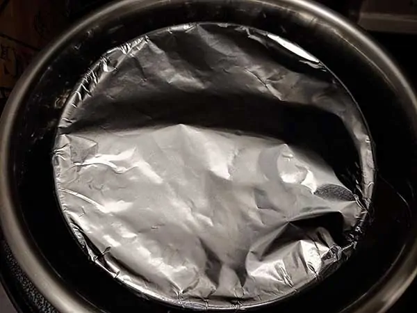 Cake pan topped with aluminum foil inside Instant Pot.