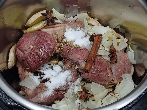 Beef shanks and aromatics in pot.