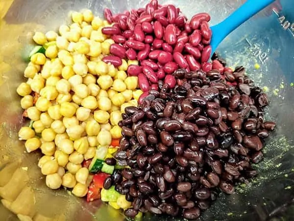 Chickpeas, kidney beans, and black beans in mixing bowl.