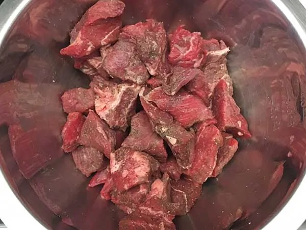 seasoned stew beef pieces in large mixing bowl