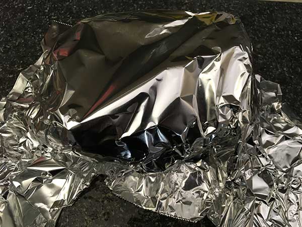 Aluminum foil covering corned beef brisket.