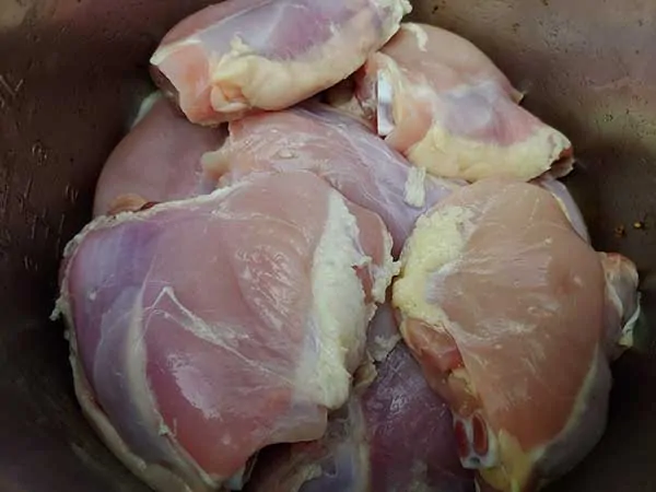 Uncooked skinless chicken thighs.