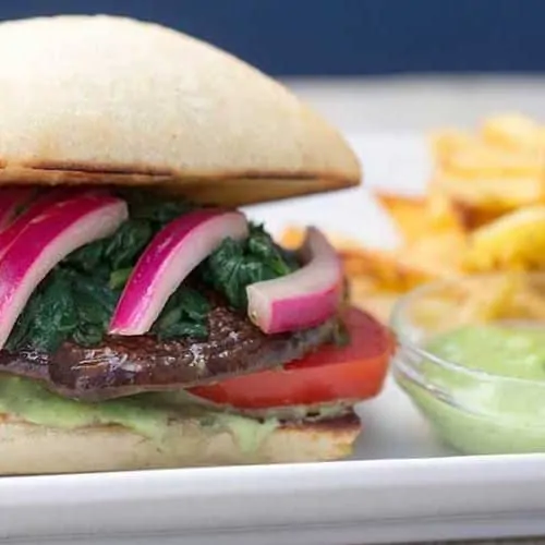 air fryer portobello mushroom with toppings on bun with fries.